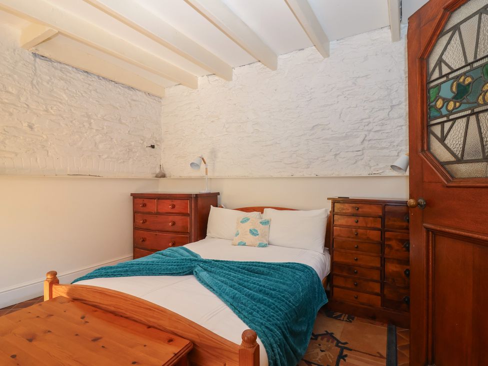 A bedroom with a bed and dressers at Tregonhawke Farmhouse in Millbrook