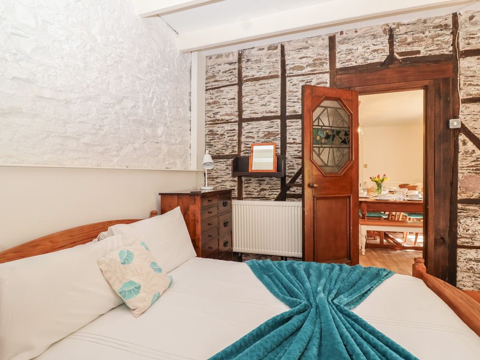 A bedroom with a bed and a door at Tregonhawke Farmhouse in Millbrook