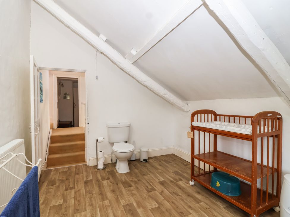 A bathroom with a toilet and changing table at Tregonhawke Farmhouse in Millbrook