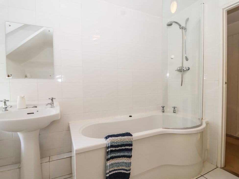 A bathroom with a shower and bathtub at Tregonhawke Farmhouse in Millbrook