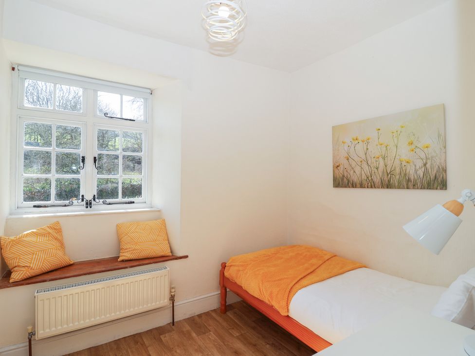 A bedroom with a bed and a window at Tregonhawke Farmhouse Millbrook