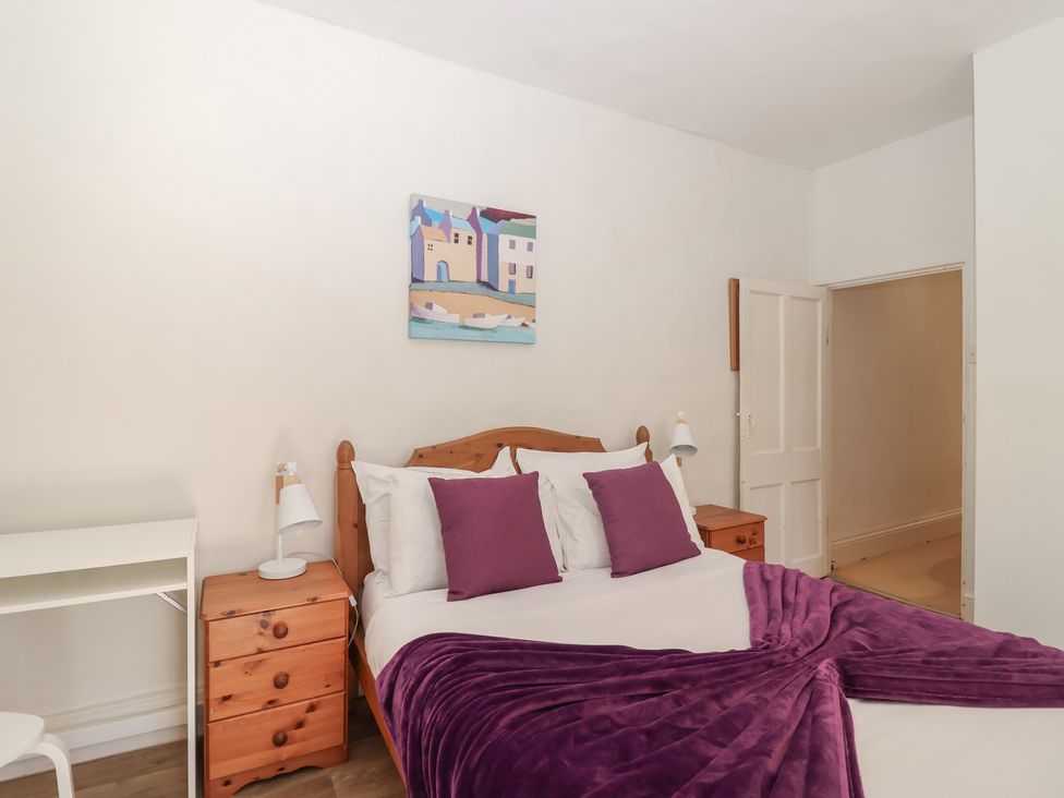 A bedroom with a bed and desk at Tregonhawke Farmhouse in Millbrook