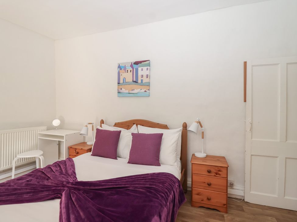 A bedroom with a bed and desk at Tregonhawke Farmhouse in Millbrook