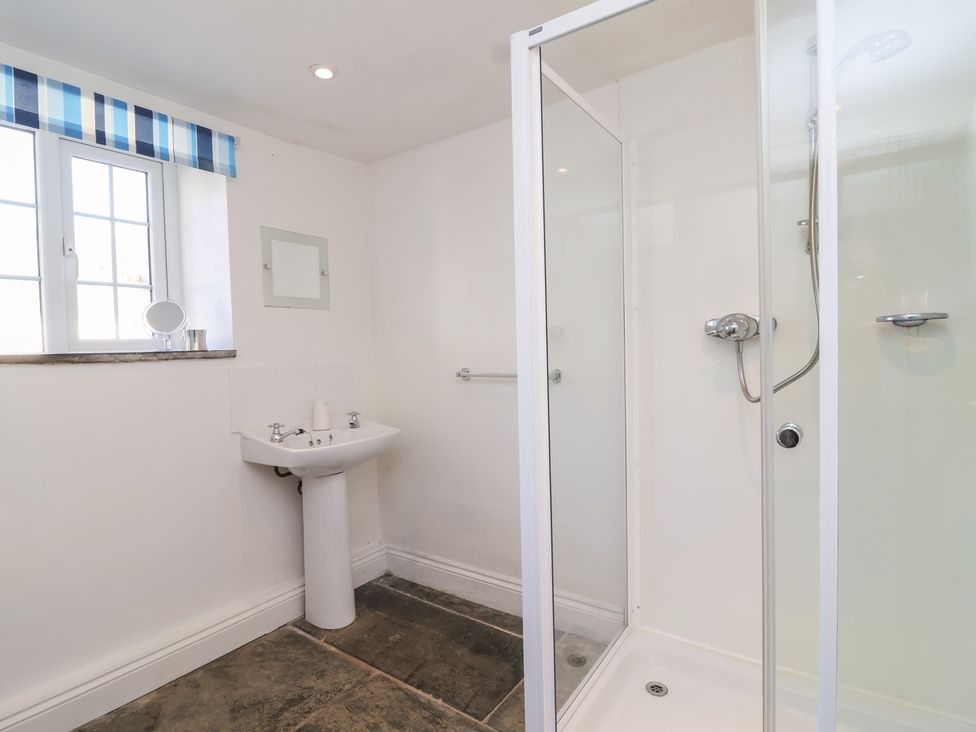 A bathroom with a shower and sink at Tregonhawke Farmhouse in Millbrook