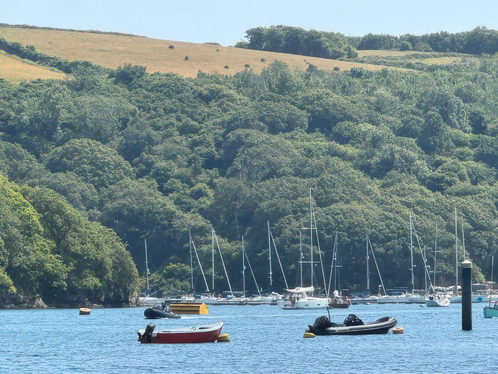 A view of boats on water with greenery and hills at Kingbarth in Lerryn