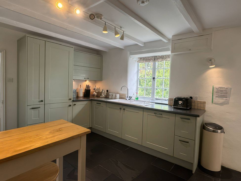 A kitchen with cabinets, sink, and a toaster at Kingbarth in Lerryn