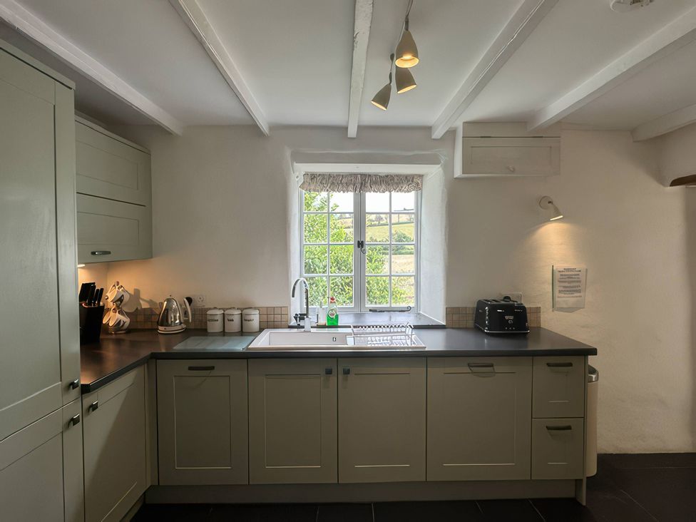 A kitchen with a sink and window at Kingbarth in Lerryn