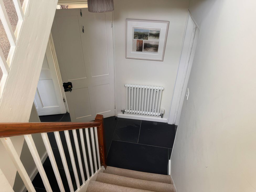 A staircase with a radiator and picture frame at Kingbarth Lerryn