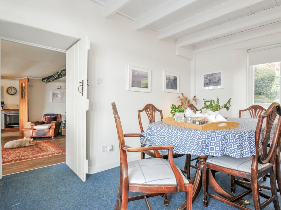 A dining room with a wooden table and chairs at Clamoak Cottage Clamoak near Bere Alston
