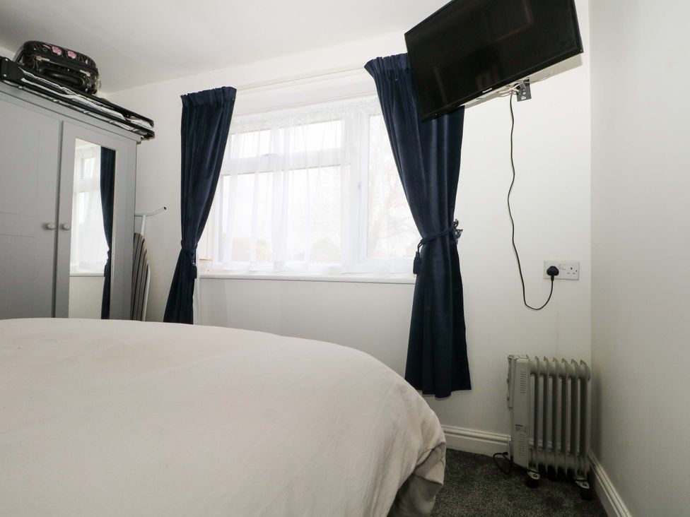 A bedroom with a bed and television at 38 St Margarets