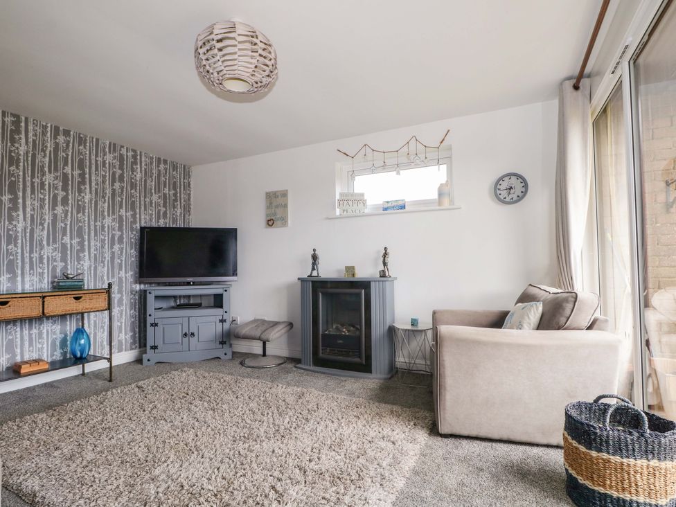 A living room with a couch and a fireplace at 38 St Margarets