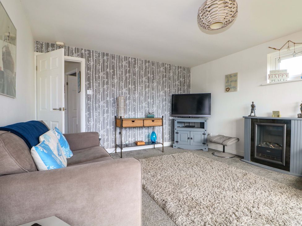 A living room with a sofa and television at 38 St Margarets