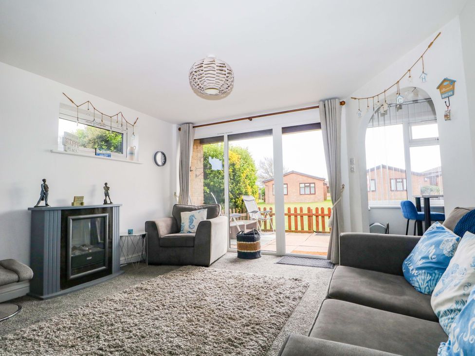 A living room with a fireplace and sofa at 38 St Margarets