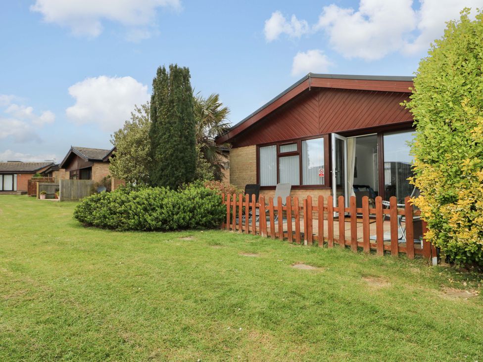 An outdoor view of a house with a patio and garden at 38 St Margarets