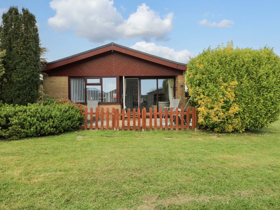 A house with a fence and bushes in front of it at 38 St Margarets
