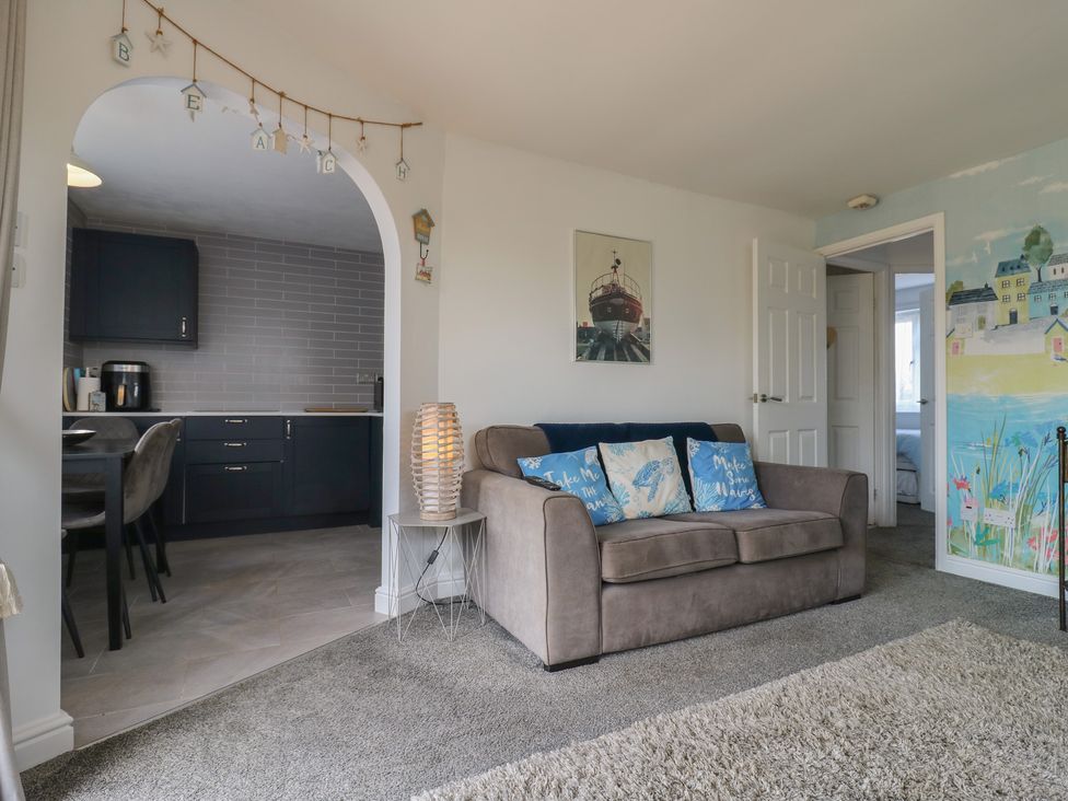 A living room with a couch and pillows at 38 St Margarets in St Margaret's At Cliffe