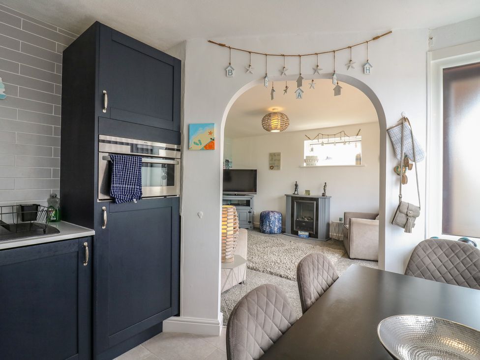 A kitchen with cabinets and a dining area at 38 St Margarets in St Margaret's At Cliffe