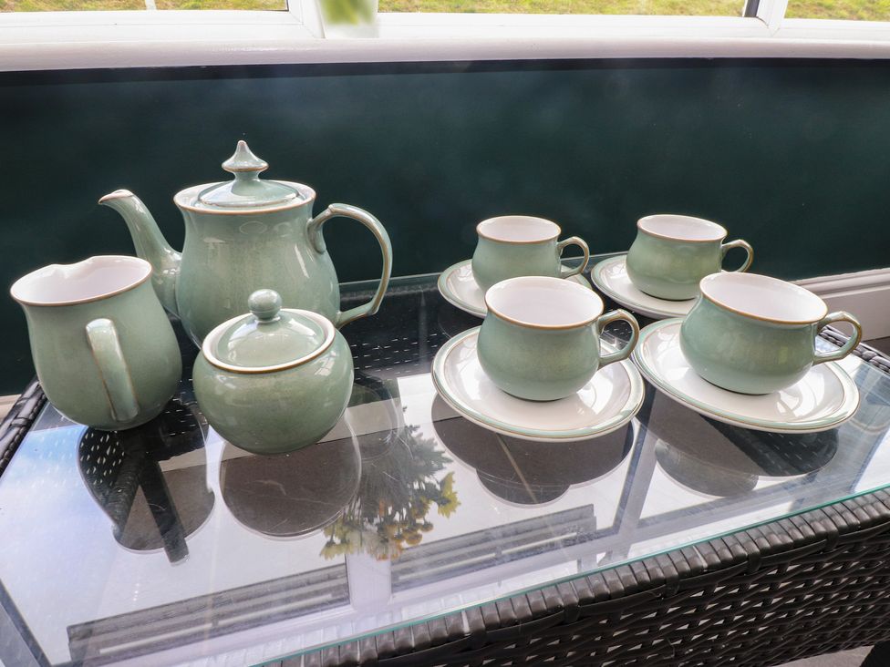 A tea set including a teapot, creamer, sugar bowl, and tea cups at Coetsiws Clynnog Fawr