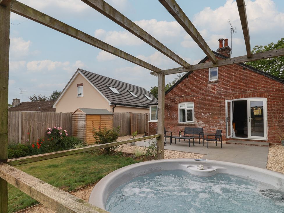 An outdoor area with a hot tub and seating at Sunny Croft Broadmayne near Dorchester