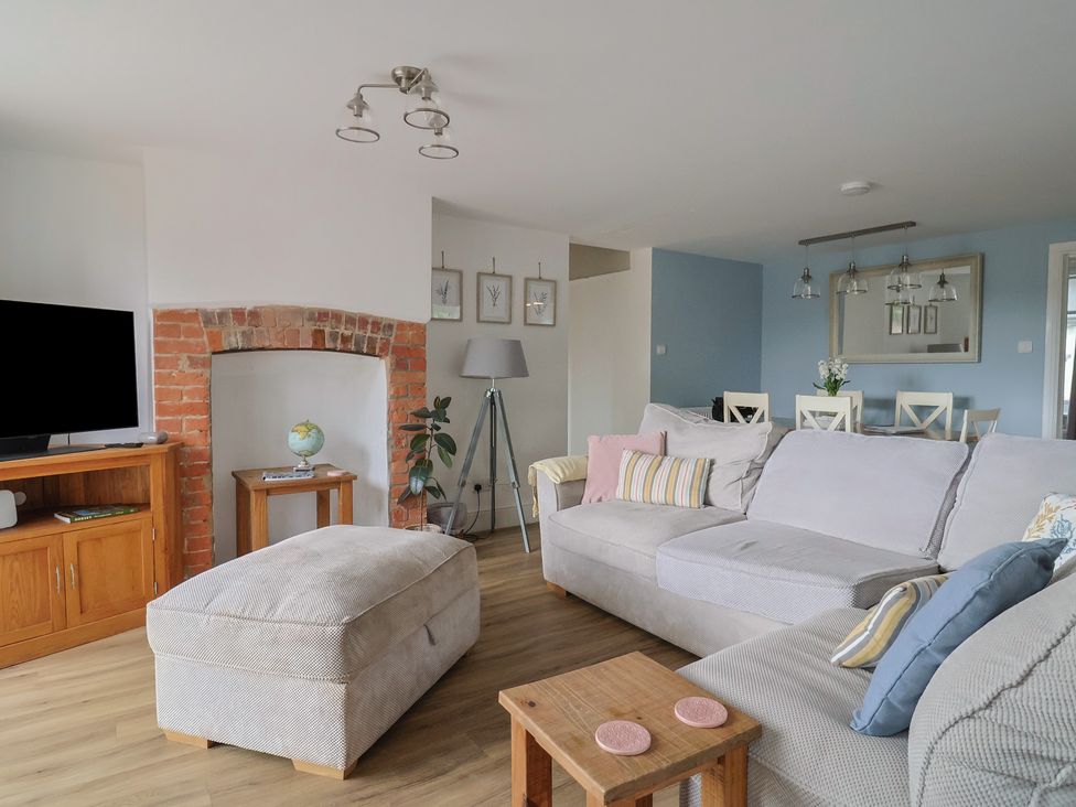A living room with a sofa and television at Sunny Croft in Broadmayne near Dorchester