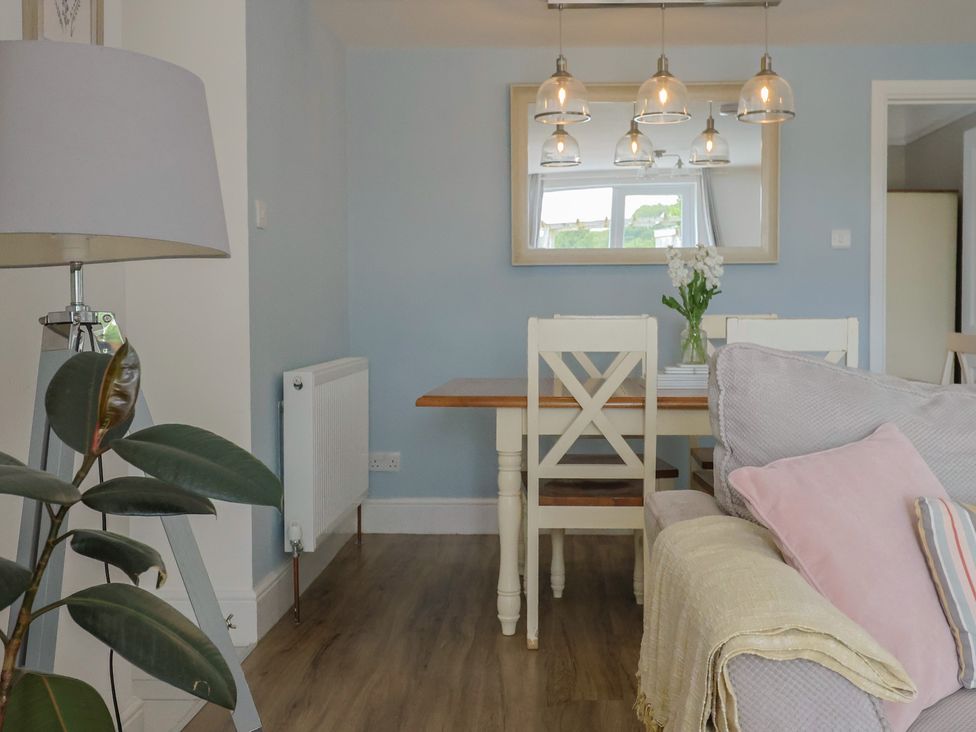 A dining room with a table and chairs at Sunny Croft in Broadmayne near Dorchester