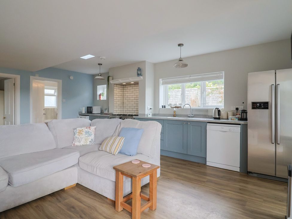 A kitchen with a sofa and appliances at Sunny Croft in Broadmayne near Dorchester
