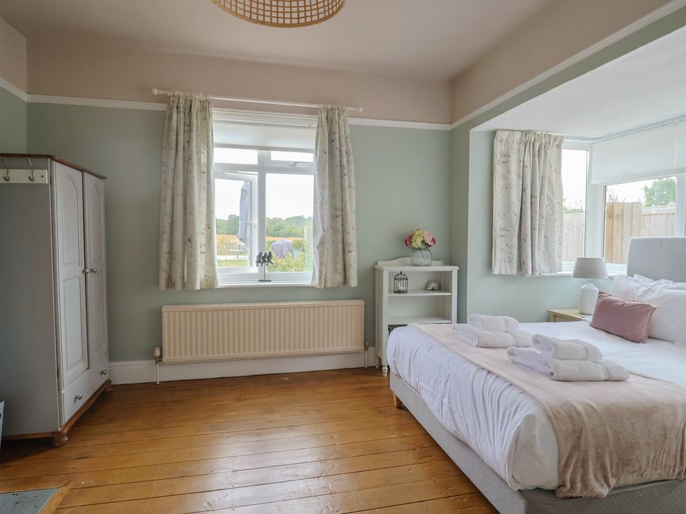 A bedroom with a bed and window at Sunny Croft in Broadmayne near Dorchester