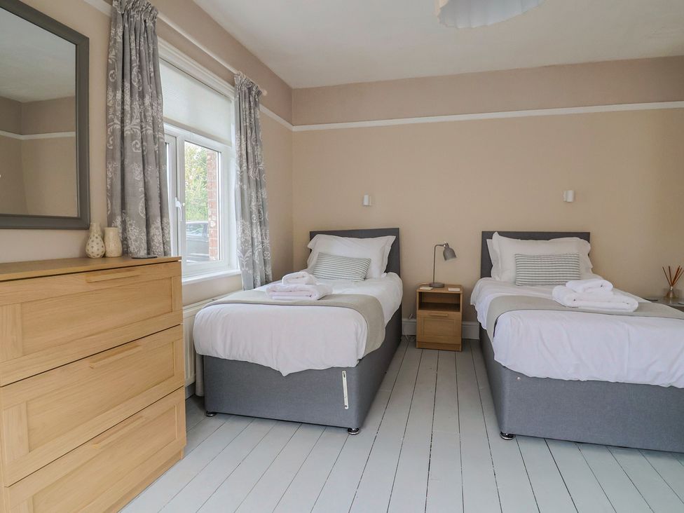 A bedroom with two beds and a window at Sunny Croft in Broadmayne near Dorchester