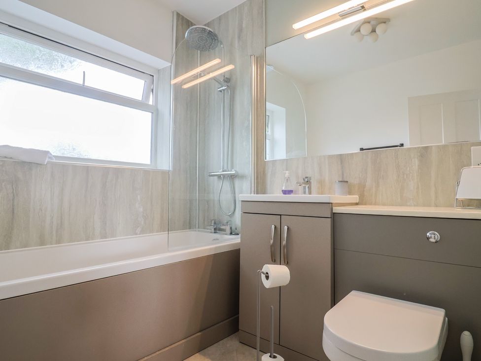 A bathroom with a shower and bathtub at Sunny Croft in Broadmayne near Dorchester