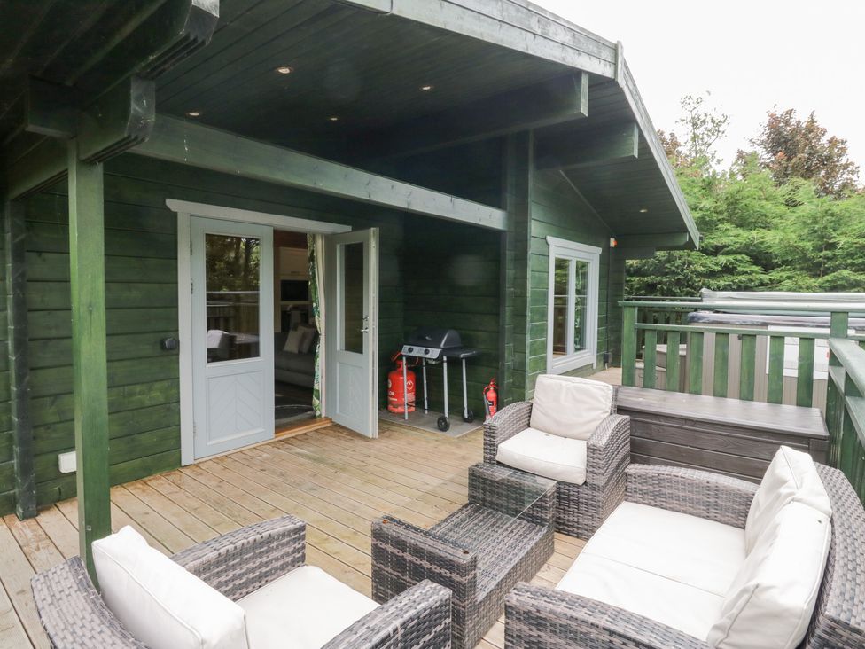 An outdoor area with seating and grill at Oak Lodge Pennington near Ulverston
