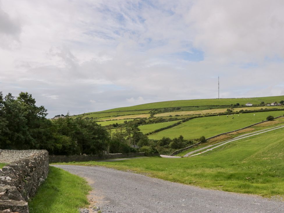 A rural landscape with a dirt road and hills at Oak Lodge in Pennington near Ulverston