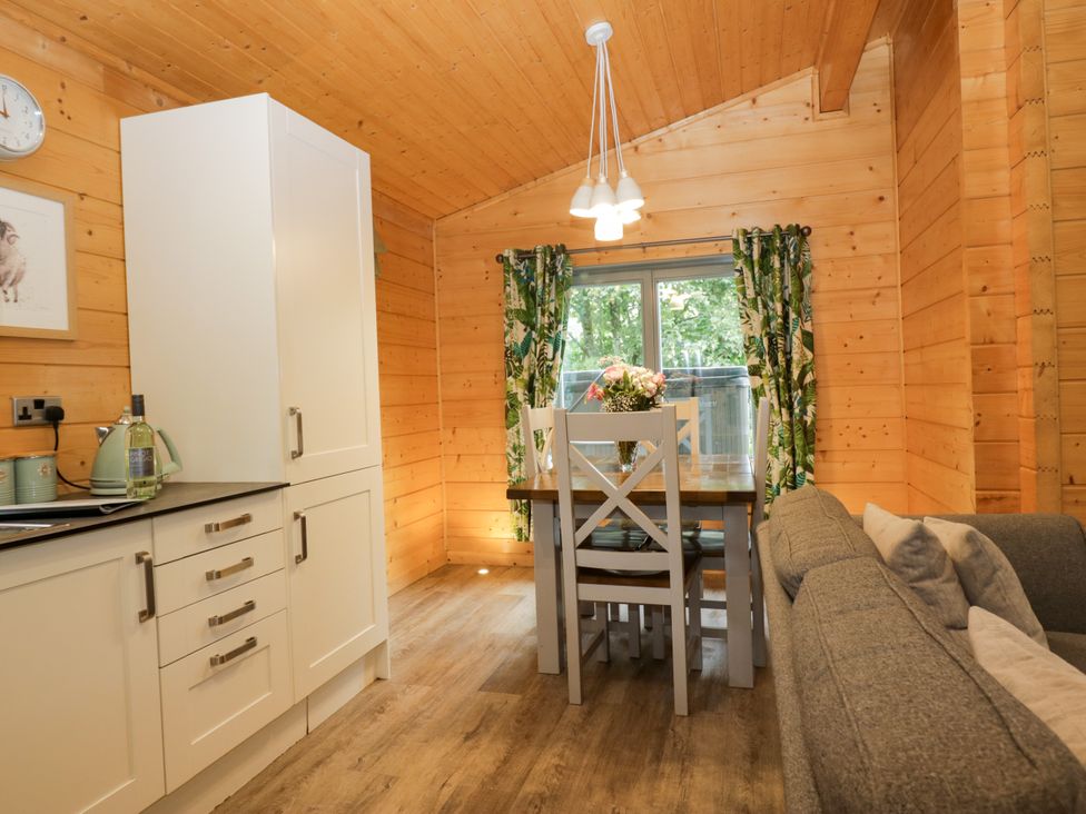 A kitchen with a table and chairs at Oak Lodge in Pennington near Ulverston