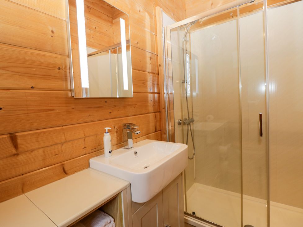 A bathroom with a sink and shower at Oak Lodge Pennington near Ulverston
