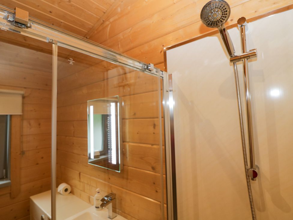 A bathroom with a shower and sink at Oak Lodge Pennington near Ulverston