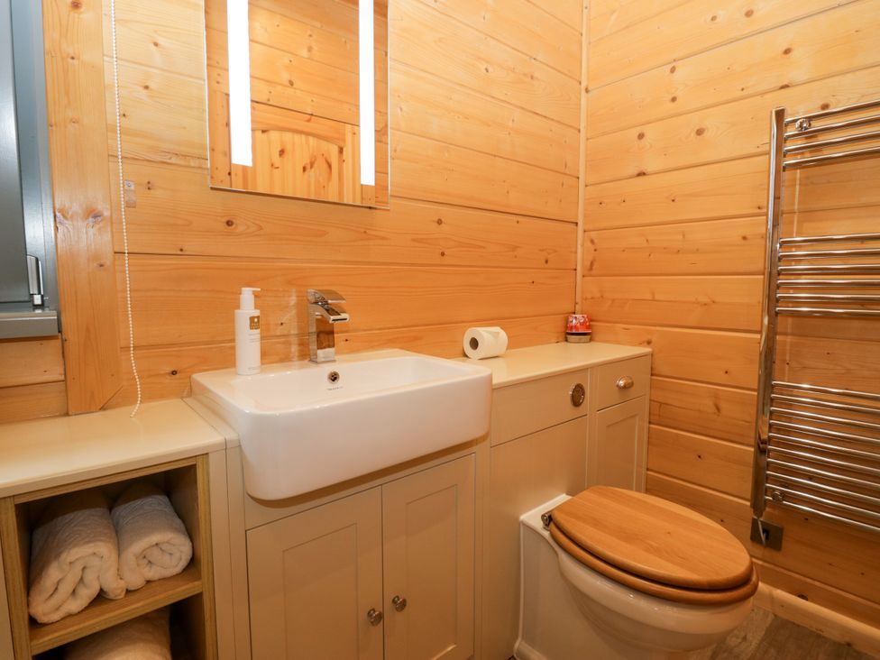 A bathroom with a sink and toilet at Oak Lodge Pennington near Ulverston