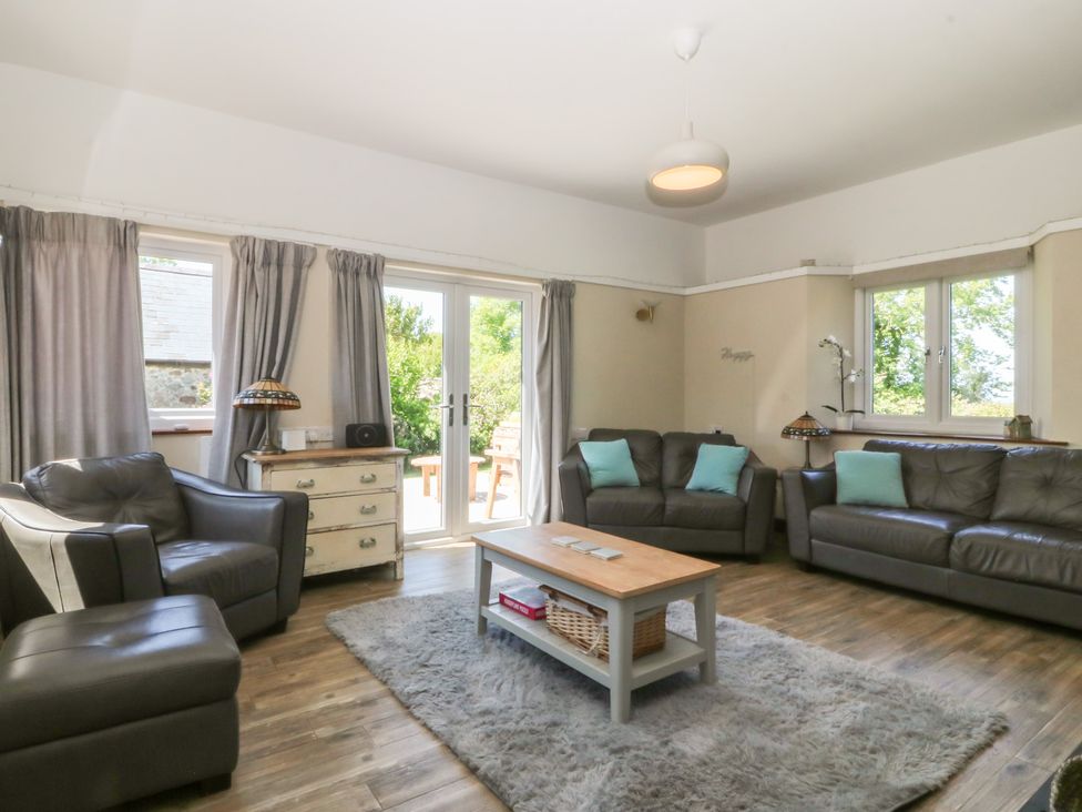 A living room with sofas and a coffee table at Tyn Morfa in Llangwnnadl near Aberdaron
