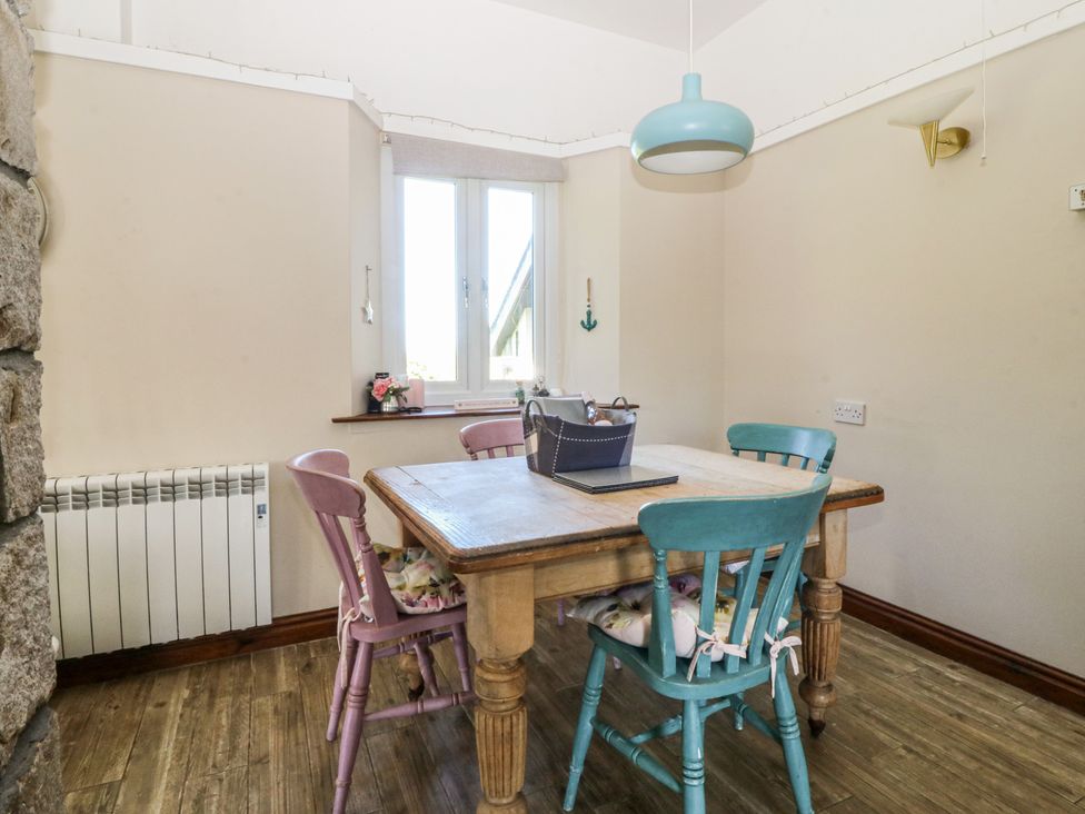 A dining room with a table and chairs at Tyn Morfa Llangwnnadl near Aberdaron