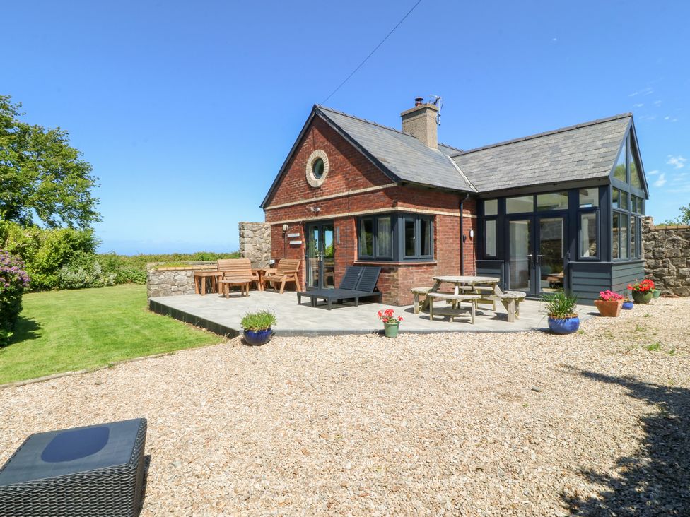 A house with a garden and patio table at Tyn Morfa in Llangwnnadl near Aberdaron