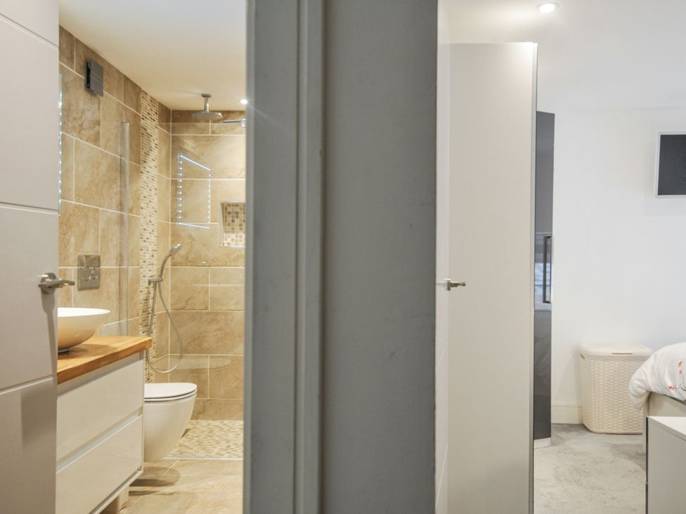 A bathroom with a shower and sink at Beach Retreat in Looe