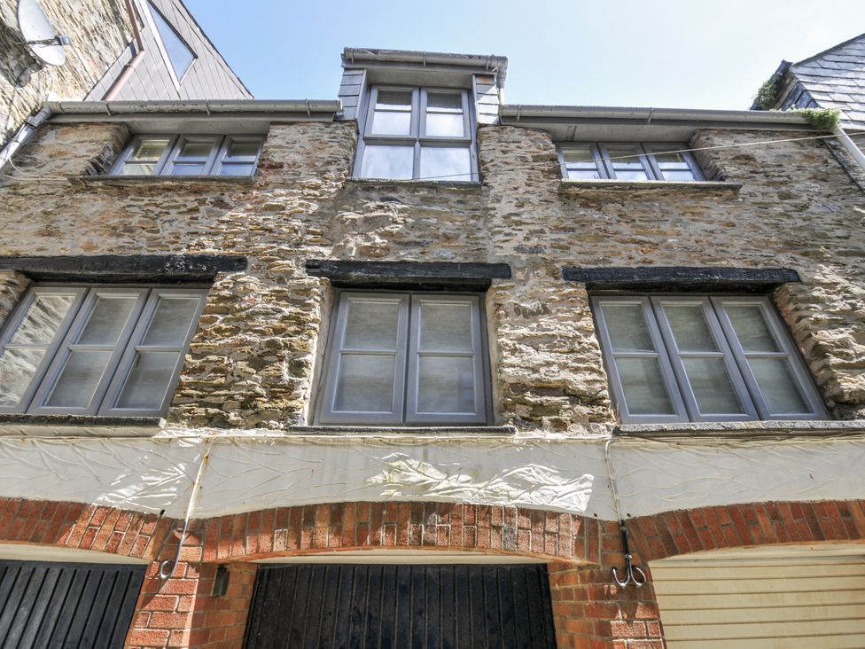 A building with stone walls and windows at Beach Retreat in Looe