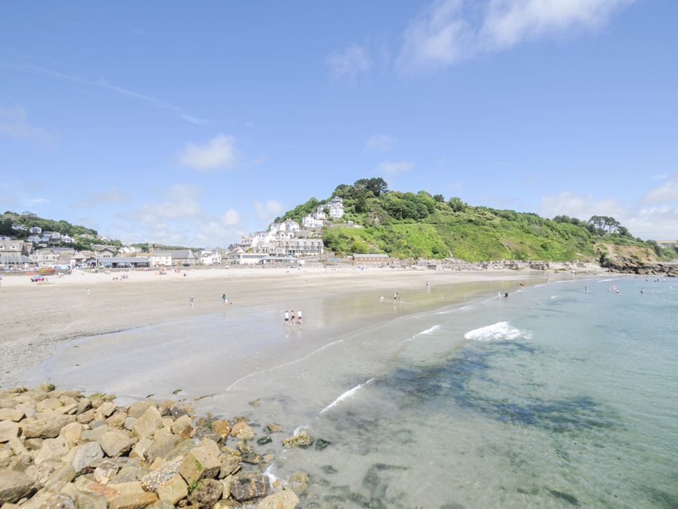 A beach with water and people at Beach Retreat in Looe