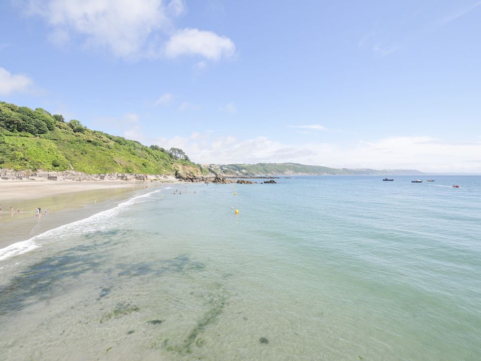 A beach with water and boats at Beach Retreat in Looe