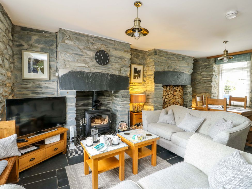 A living room with a fireplace and sofa at Garreg Ddu in Blaenau Ffestiniog
