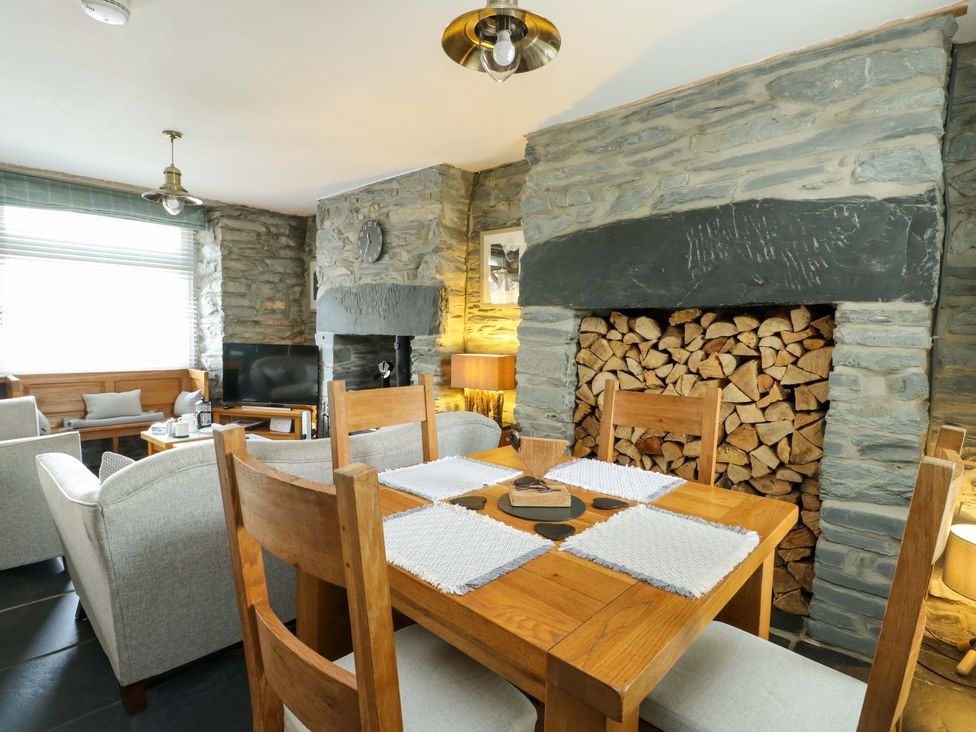 A dining room with a wooden table and chairs at Garreg Ddu in Blaenau Ffestiniog