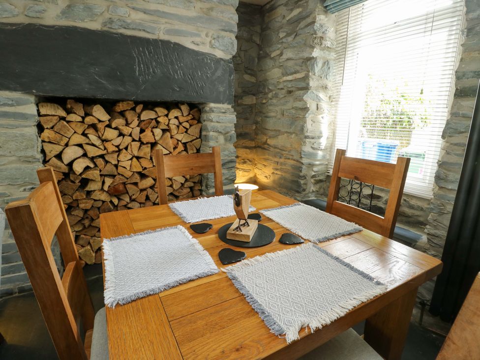 A dining room with a wooden table and chairs at Garreg Ddu in Blaenau Ffestiniog