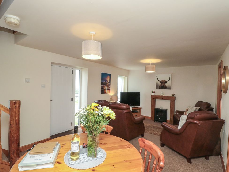 A living room with furniture and decor at Milton Cottage in Hawsker near Whitby and Robin Hood's Bay