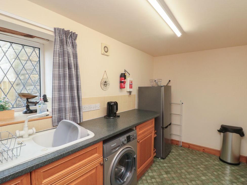 A kitchen with a sink and washing machine at Milton Cottage Hawsker near Whitby and Robin Hood's Bay