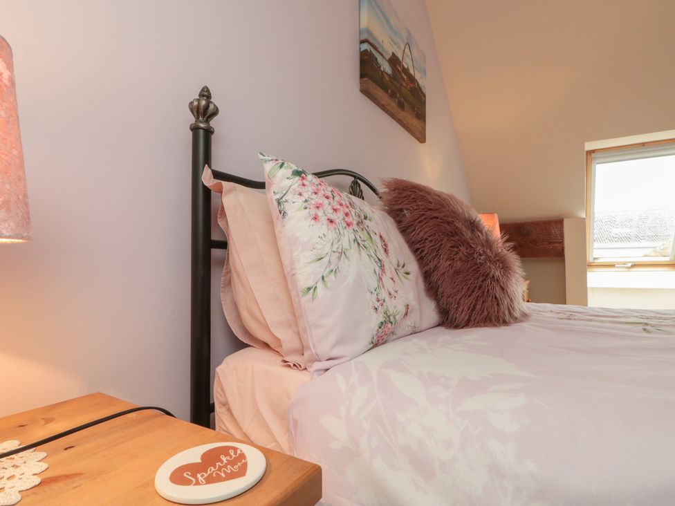 A bedroom with a bed and lamp at Milton Cottage near Hawsker near Whitby and Robin Hood's Bay