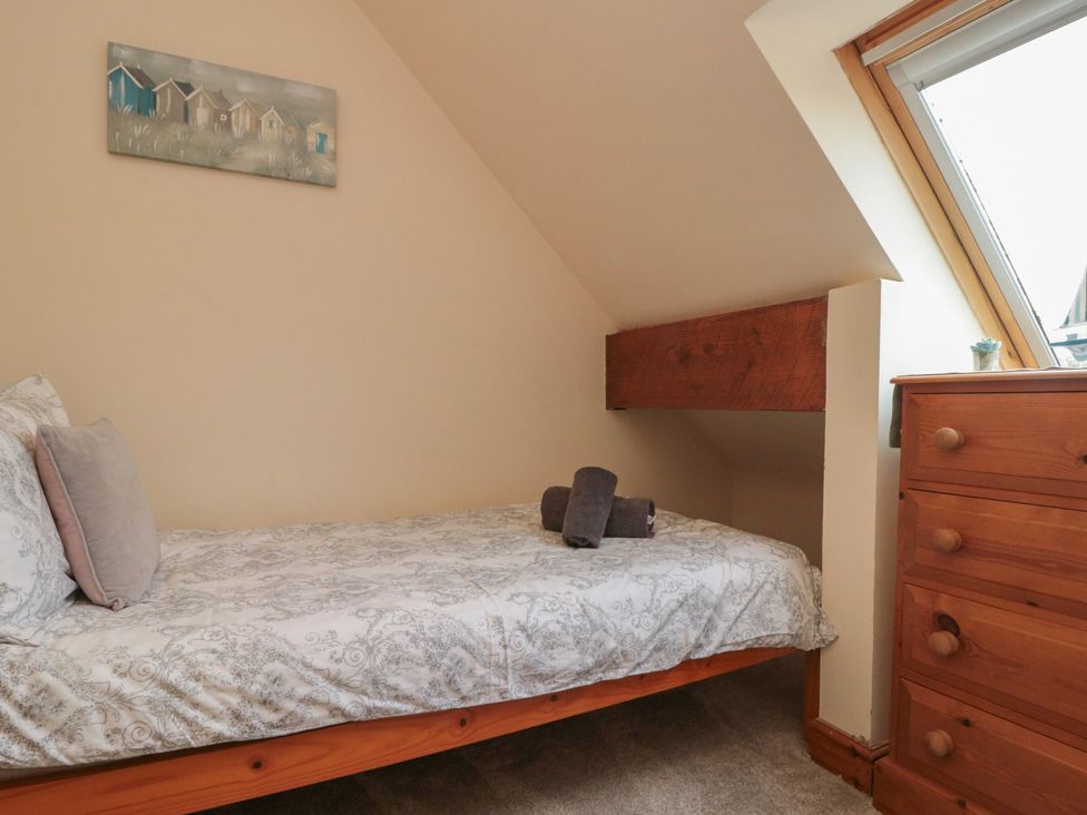 A bedroom with a bed and dresser at Milton Cottage Hawsker near Whitby and Robin Hood's Bay