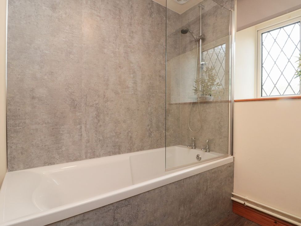 A bathroom with a shower over a bathtub at Milton Cottage Hawsker near Whitby and Robin Hood's Bay